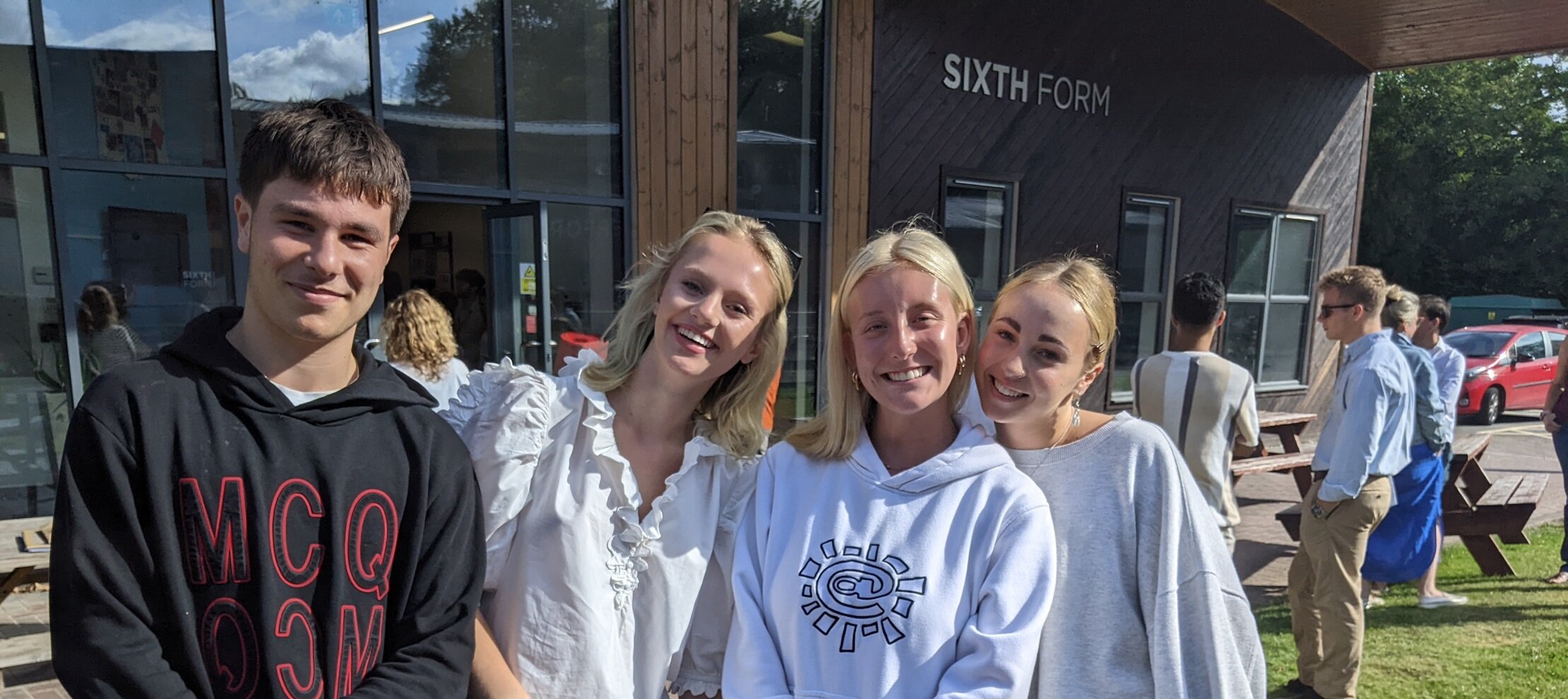 four students smiling 