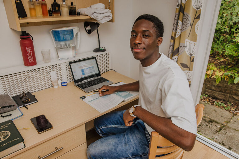 a student with the computer at the desk