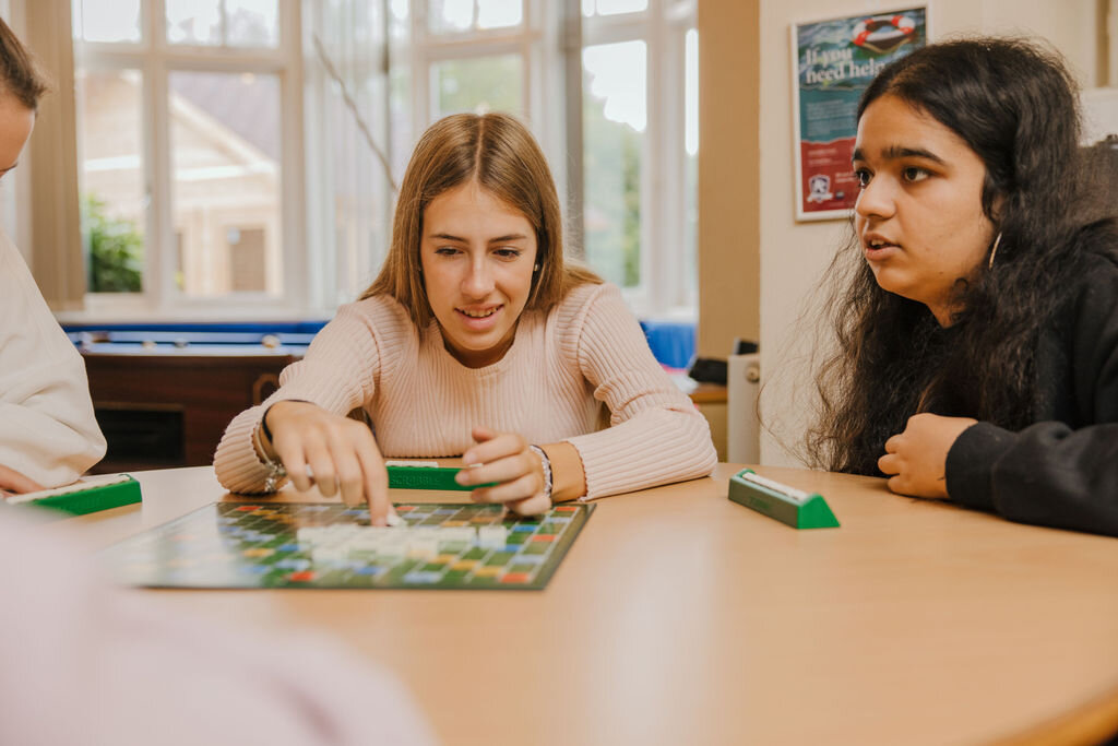 three students playing a game 