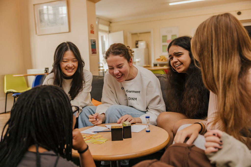 four students playing a game