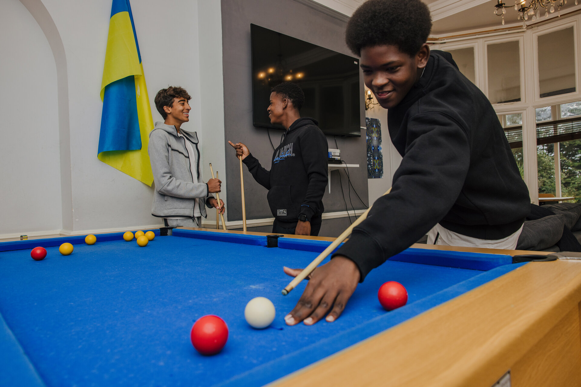 student playing billiards