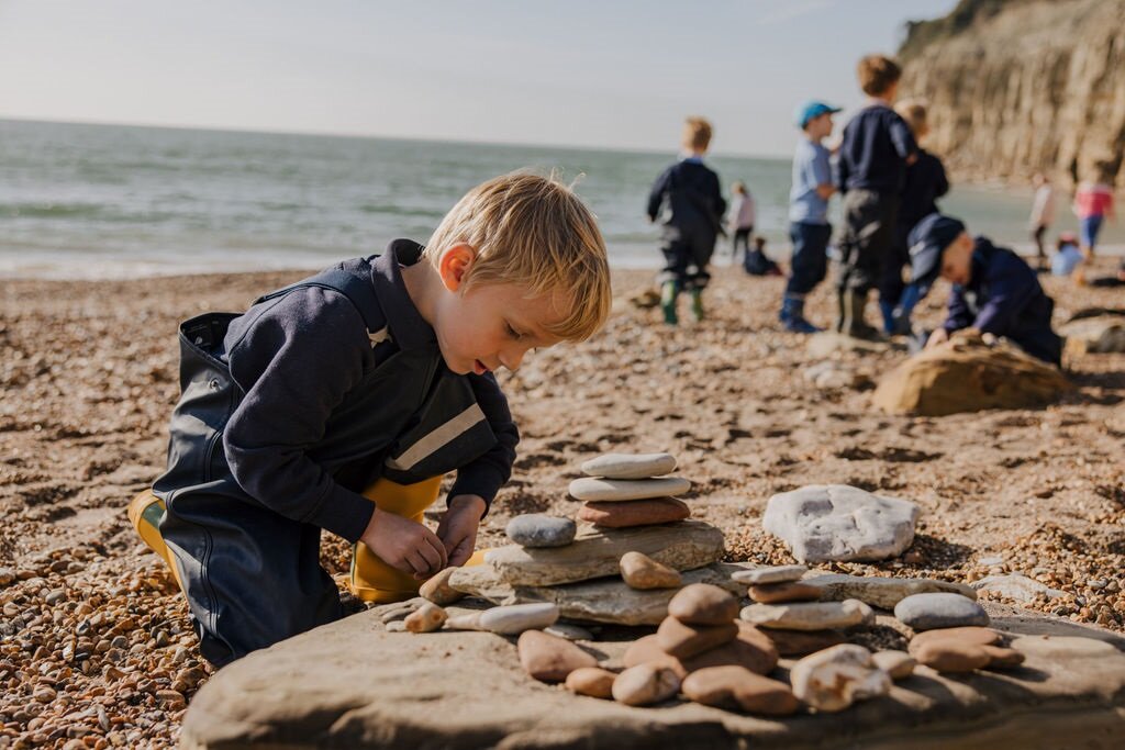 a student playing with a stone