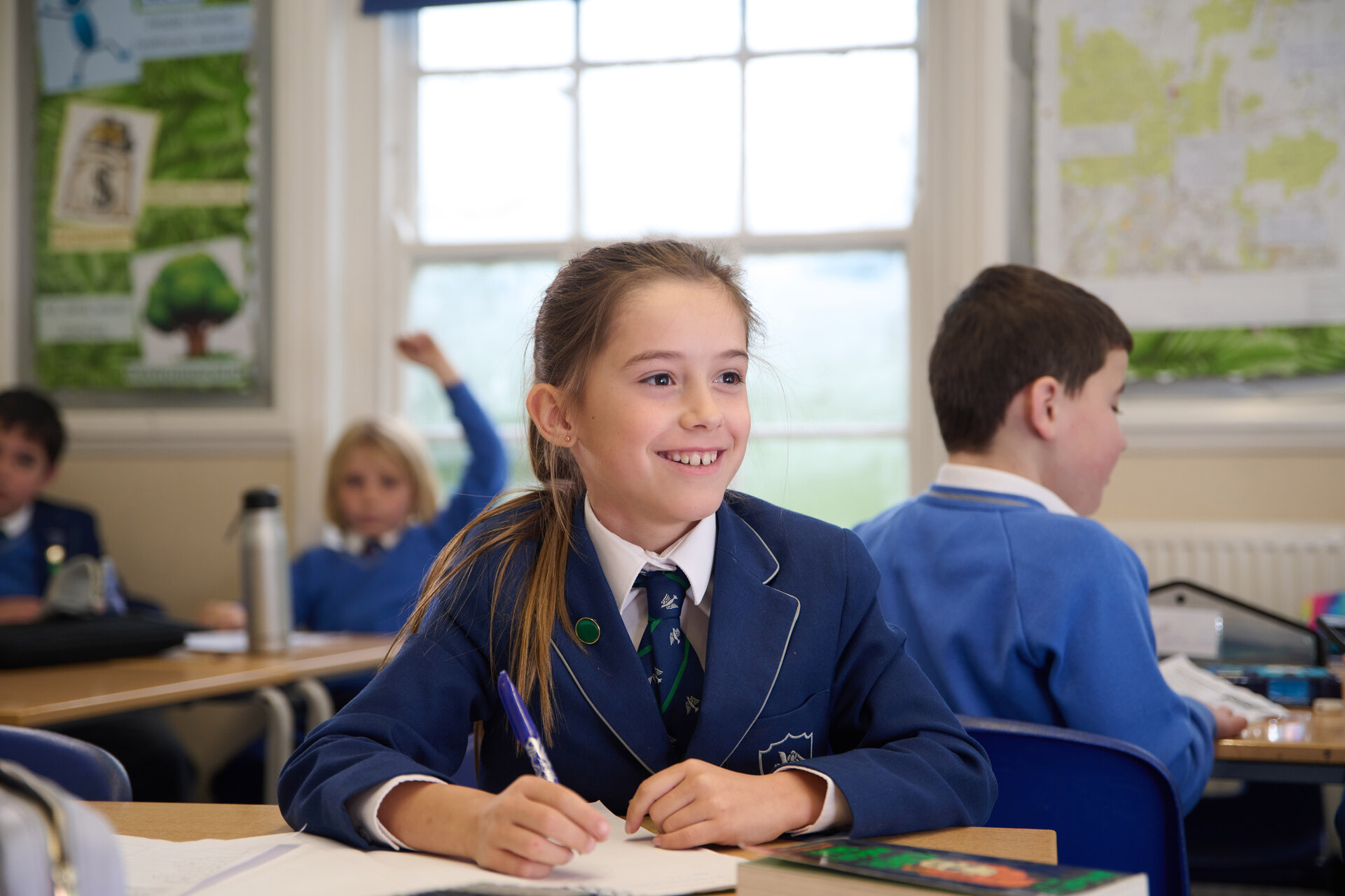 a student writing and smiling