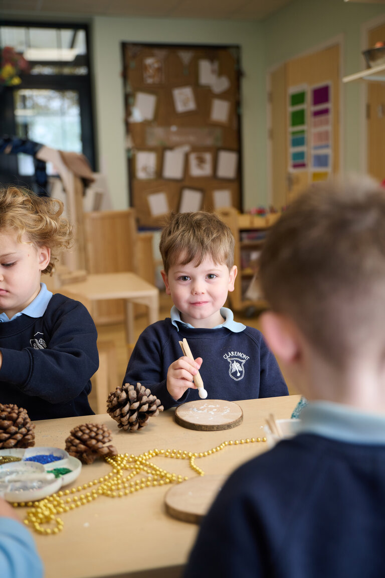 students doing wood and pinecone crafts