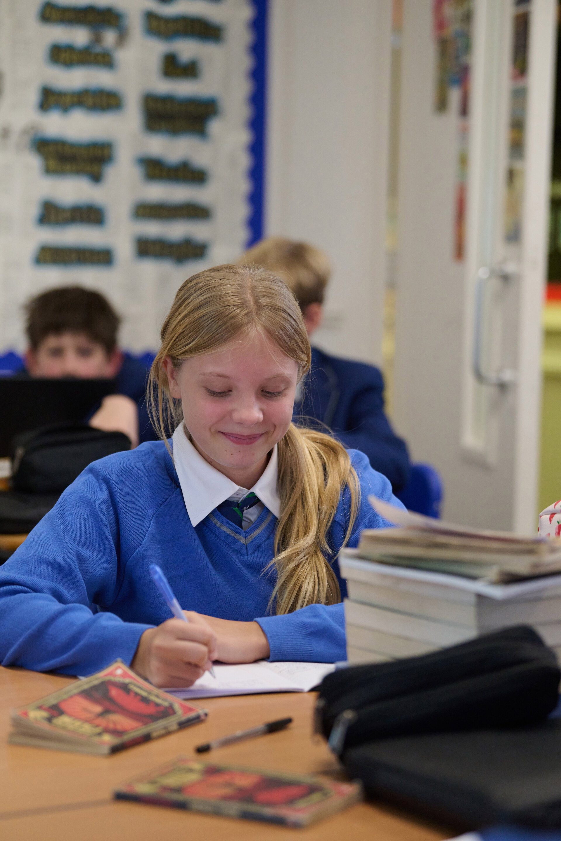 student writing in the classroom